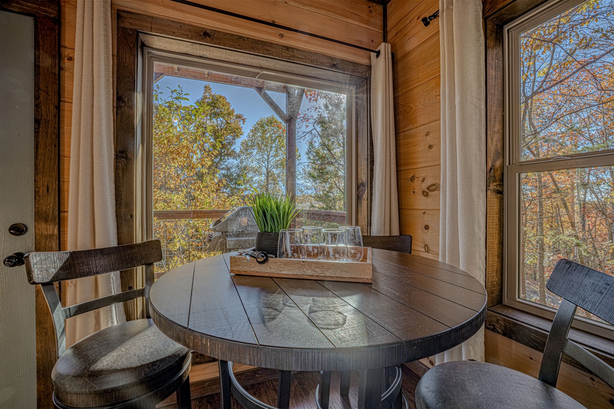 Cozy breakfast nook with wooded views — perfect for morning coffee.