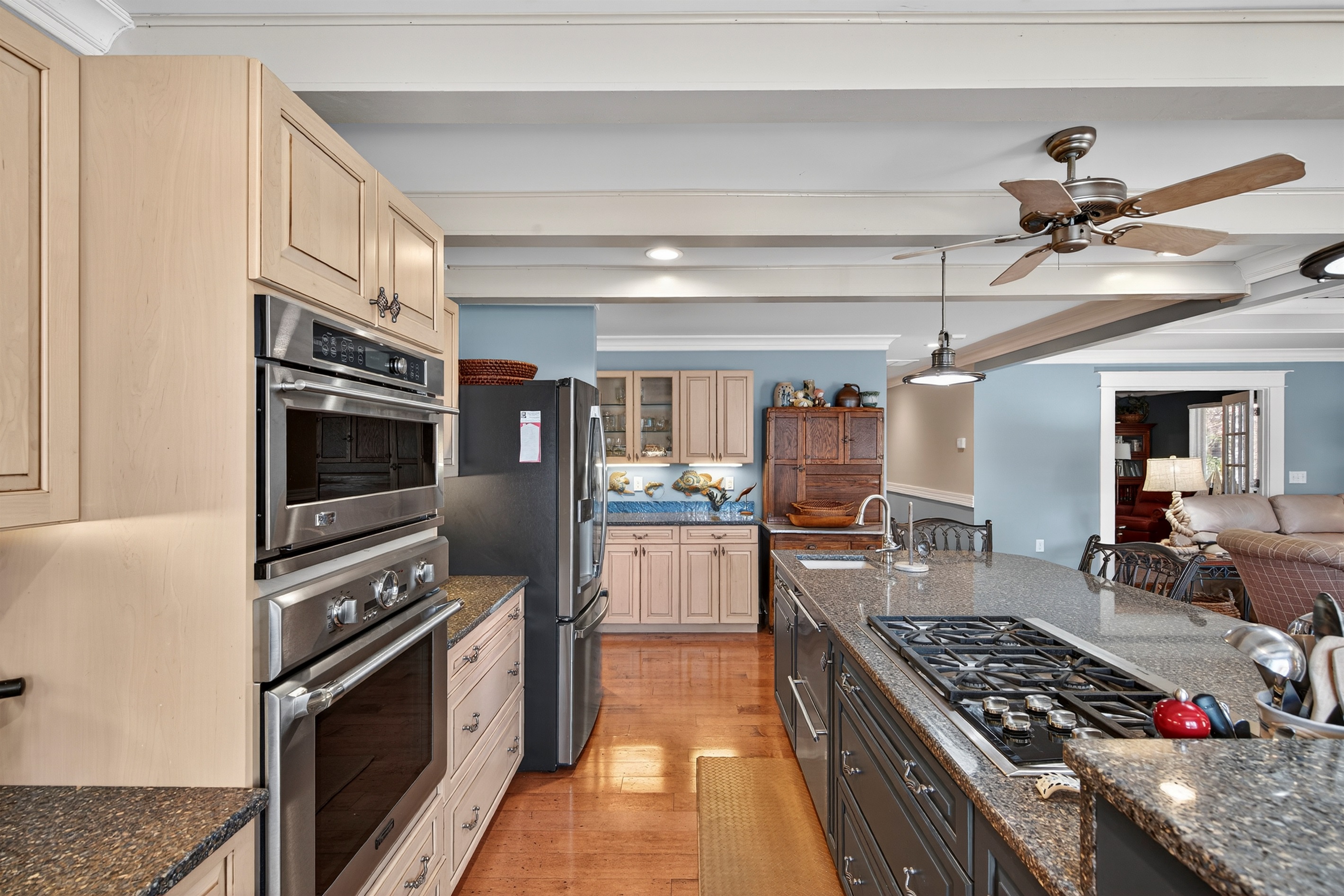 Fully stocked kitchen featuring double ovens, gas cooktop, and stainless appliances.