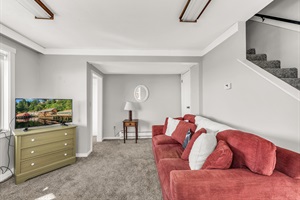 Recreation room with salmon couch and tv