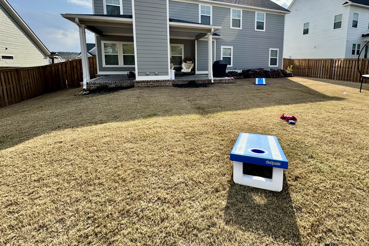 Enjoy a friendly game of cornhole in your own private backyard retreat