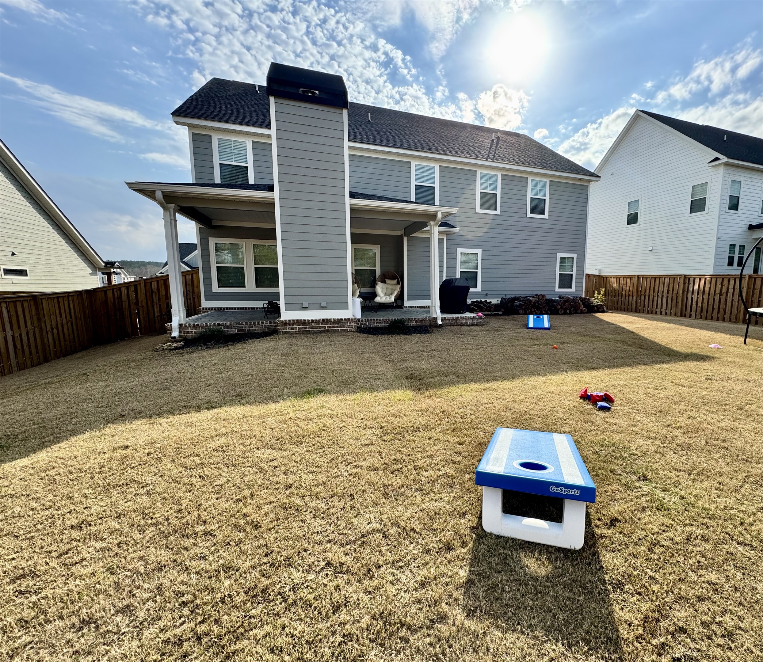 Enjoy a friendly game of cornhole in your own private backyard retreat
