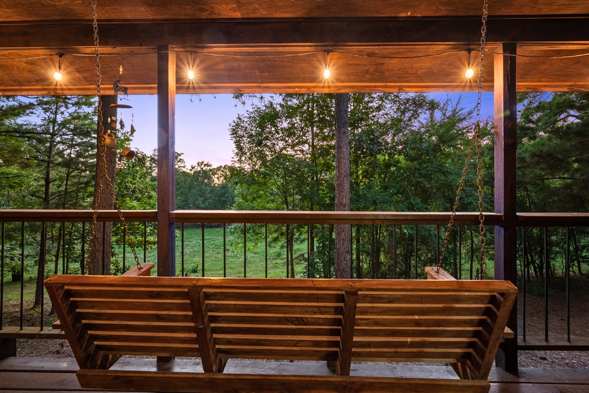 Unwind side-by-side on these peaceful rocking chairs with serene views of the trees.