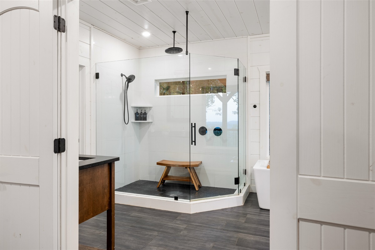 Modern spa-style bathroom with glass shower and elegant clean finishes