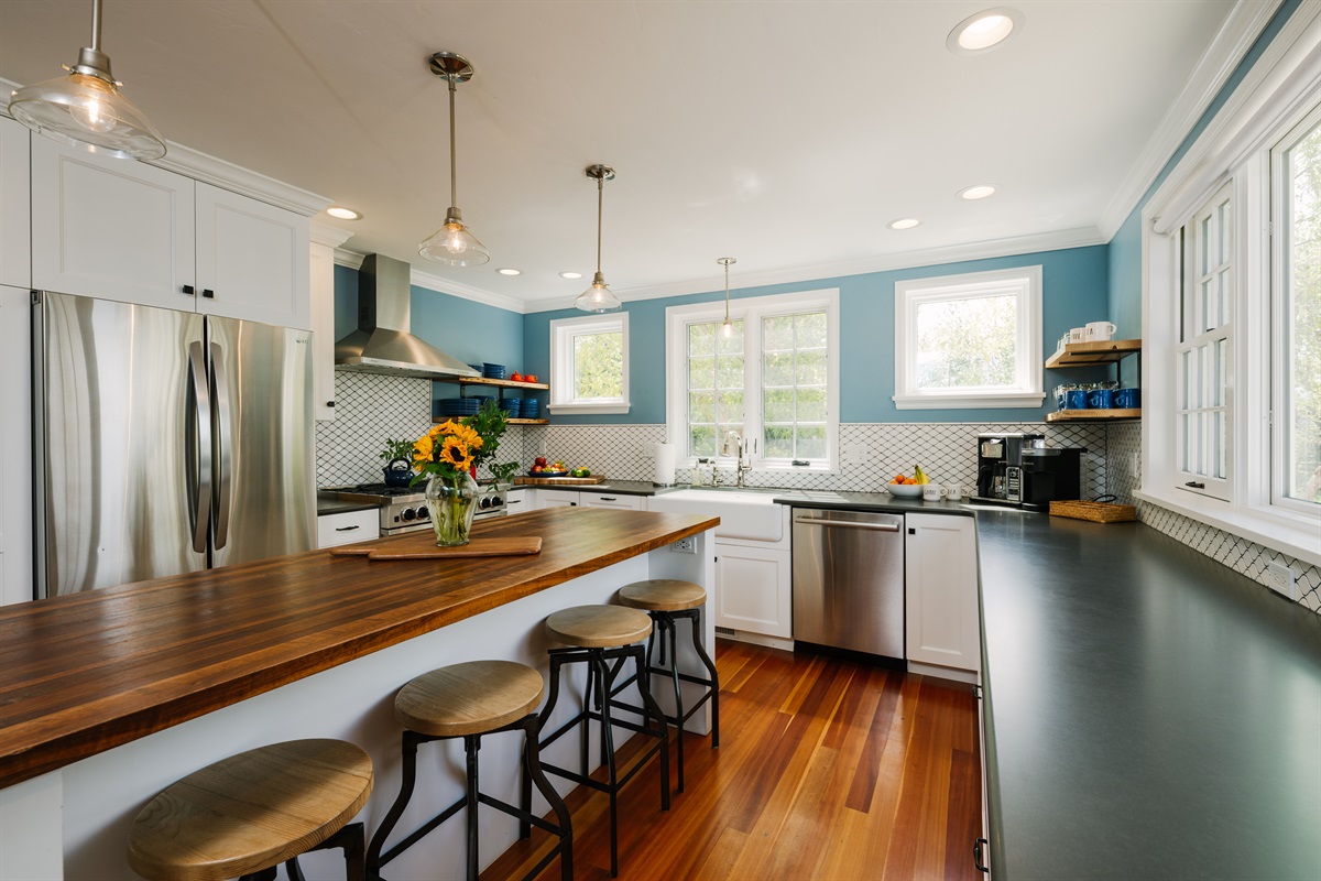 Large butcher block island/seats for 4. (Butcher block island is for decor & general use only. Wood cutting boards are provided for cutting and food preparation). 