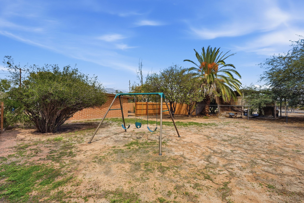 Kid-Friendly Play Space: Features a classic backyard swing set to keep the little ones entertained during your stay.