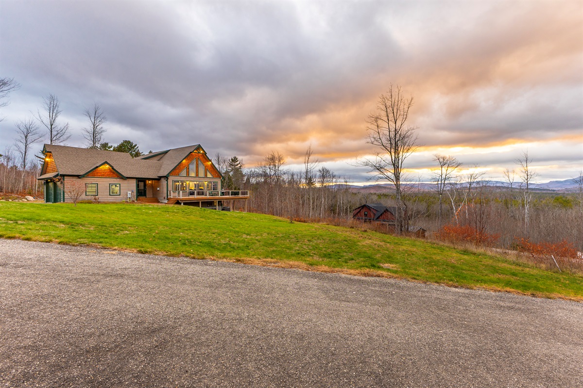 Experience the lodge’s inviting exterior and breathtaking mountain views.