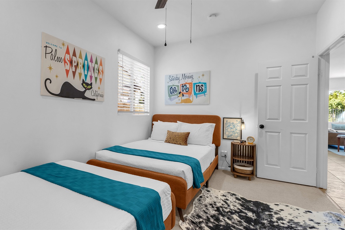Comfort meets fun in this cozy twin bedroom featuring cheerful décor and a ceiling fan for added comfort