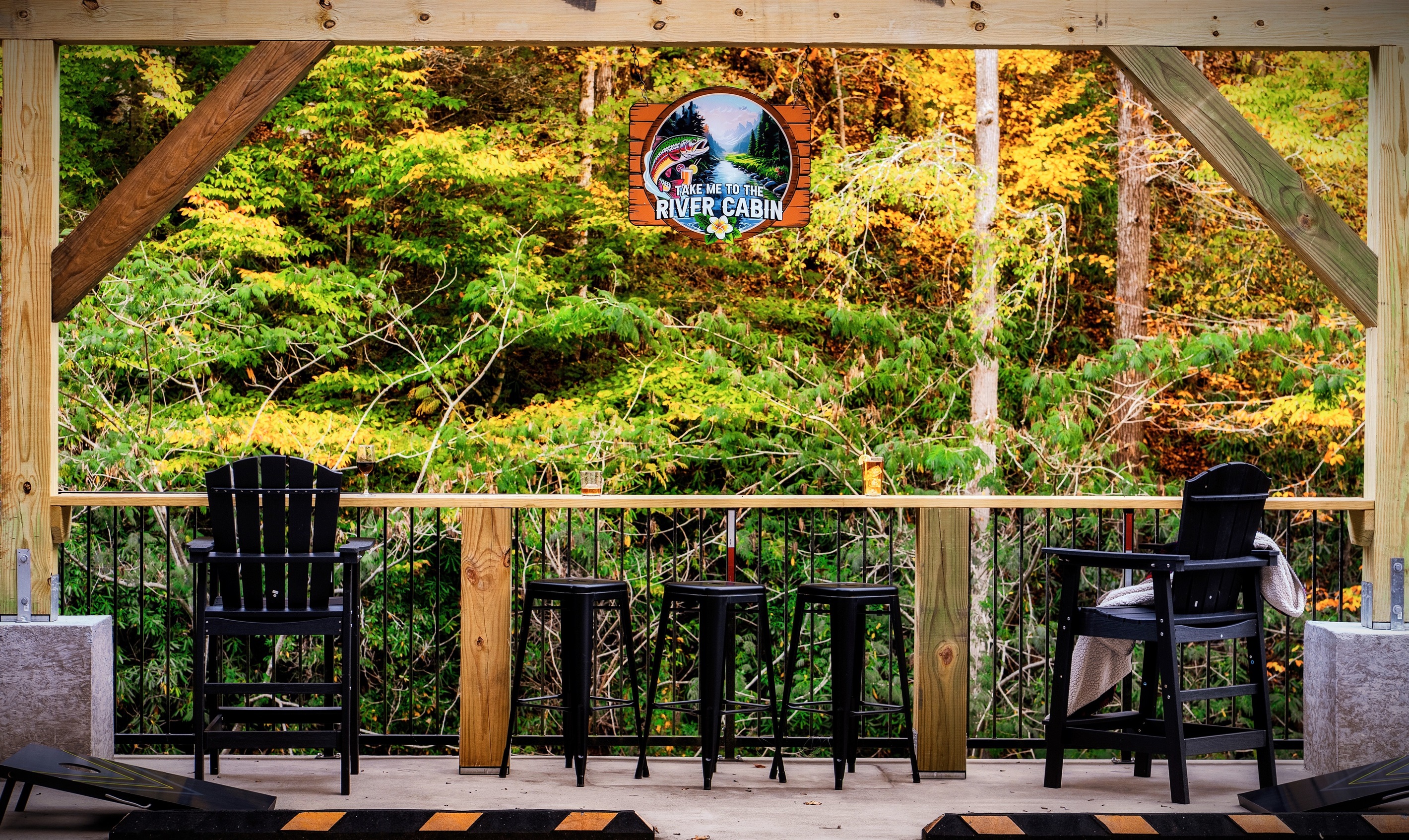 A bar table area that overlooks the Little Pigeon River. A definite one-of-a-kind experience to listen in to the rushing sound of water while enjoying a conversation with your loved ones!
