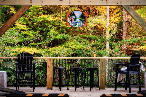 A bar table area that overlooks the Little Pigeon River. A definite one-of-a-kind experience to listen in to the rushing sound of water while enjoying a conversation with your loved ones!