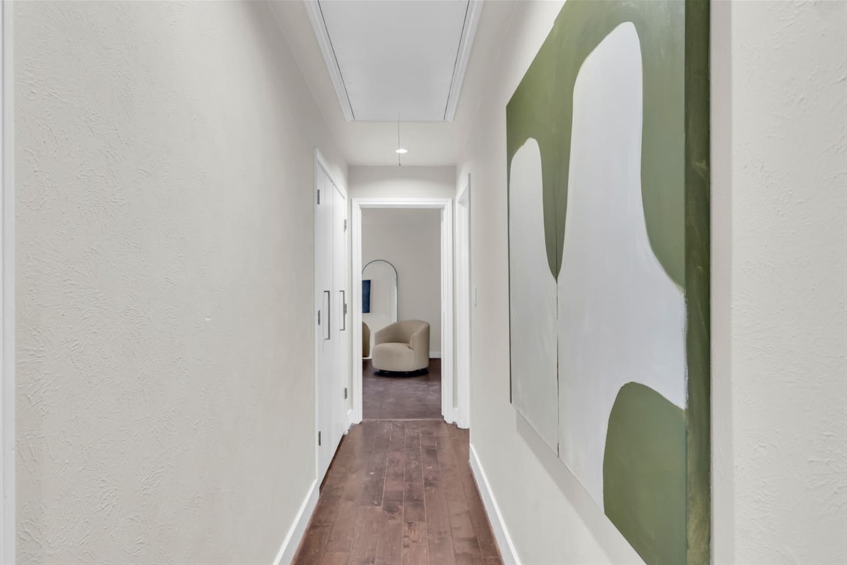 Art-lined hallway showcasing curated artwork and an upscale design aesthetic, reflecting the feel of a luxury home in one of North Dallas’s most desirable areas, just minutes from NorthPark Center shopping and dining.