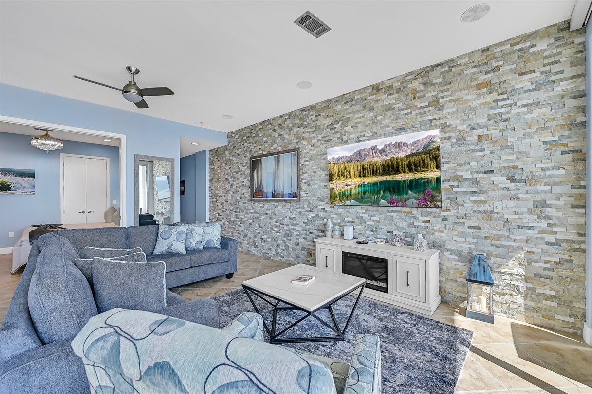 75 inch Samsung smart TV, electronic fireplace, sectional, pillows, open living 200 sq ft.