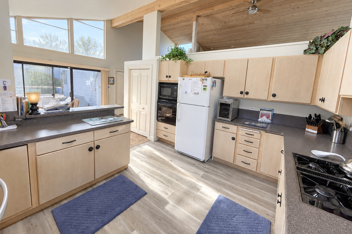 Appliances facing towards dining and patio area with barbecue and hot tub
