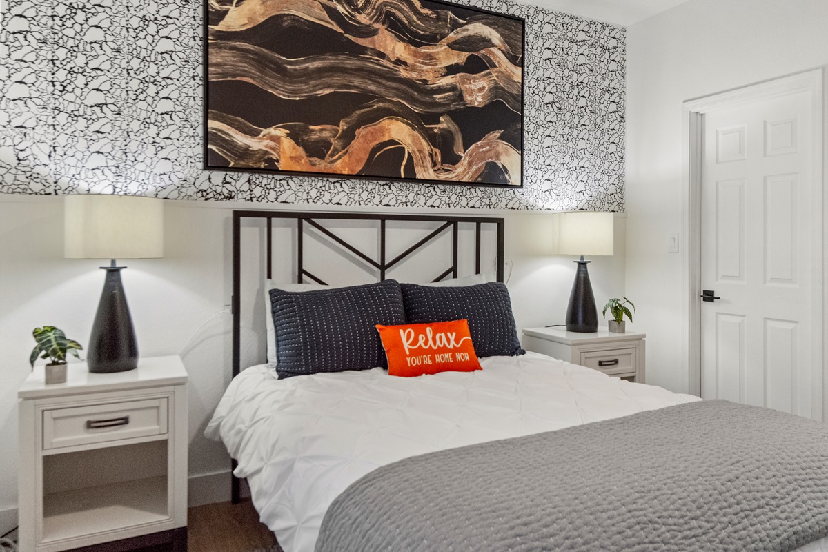 A serene retreat features a luxurious bed with premium linens, soft pillows, and a cozy mattress that ensures restful sleep and ultimate comfort throughout your visit.