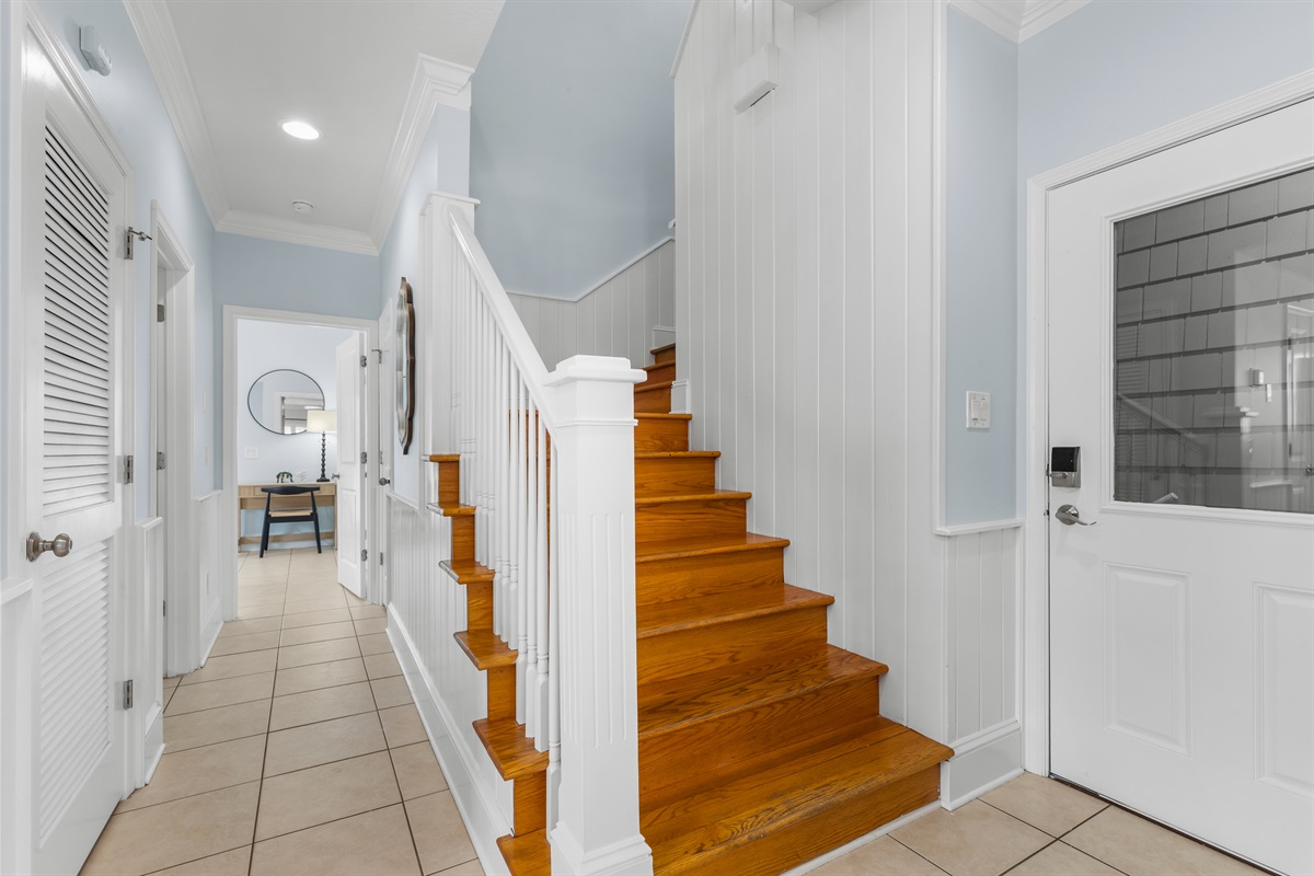 Entry door at main level. Just down the hall is the half bath for convenience, Up the stairs are the 4 remaining bedrooms