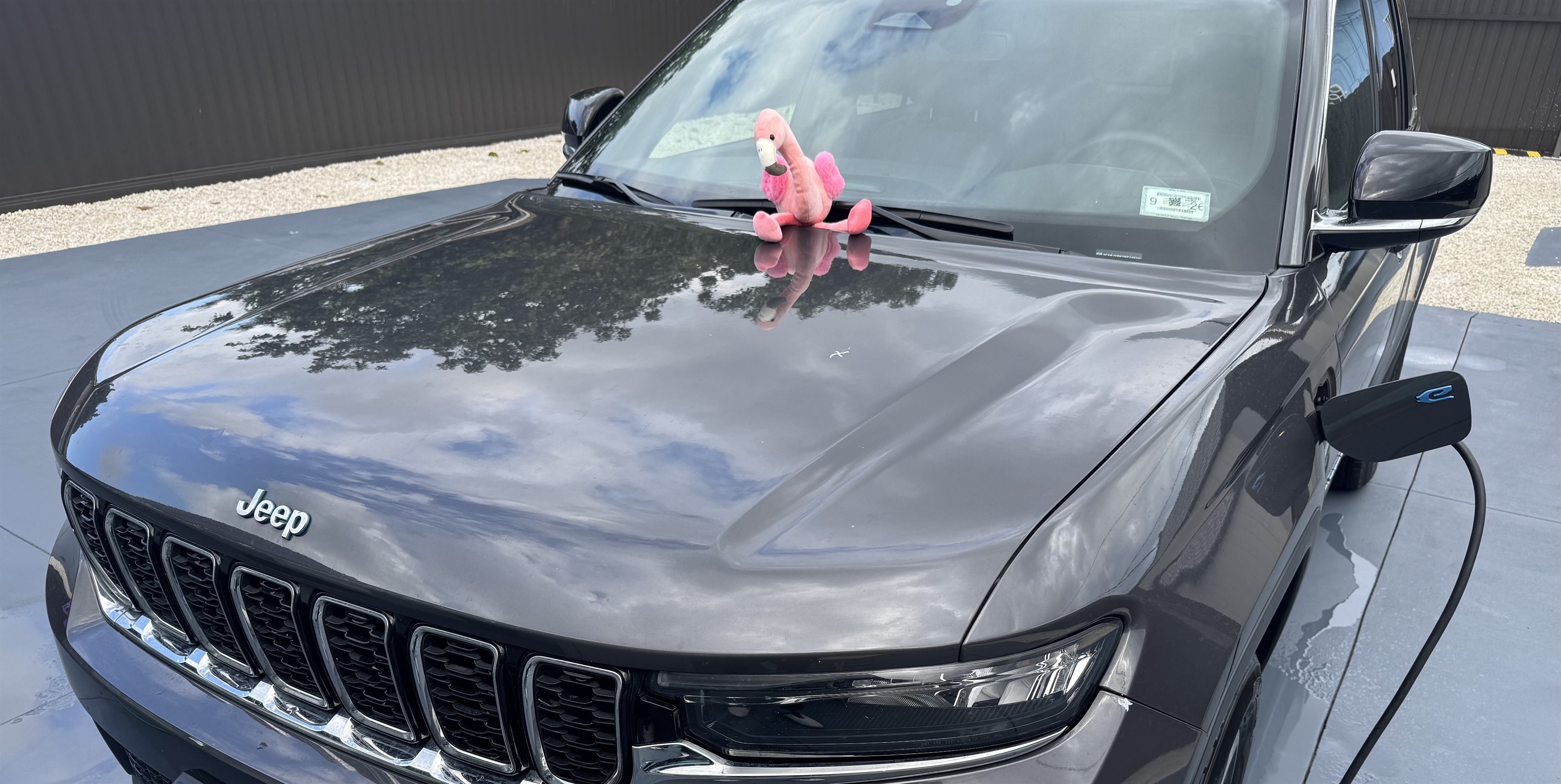 American Electric Vehicle EV is charging with a JJ1772 adapter. The charging station is in the gated backyard area and yes you are permitted to park on the concrete only while charging your EV. We have two adapters available, NACS and JJ1772.