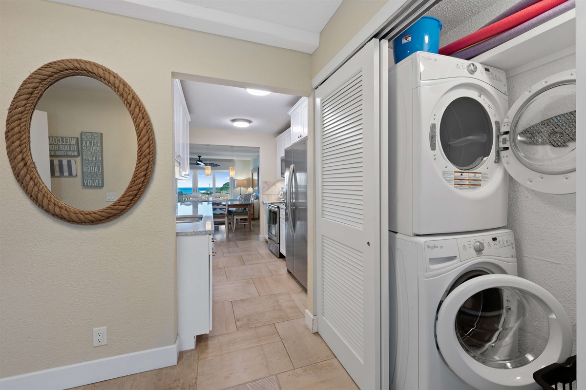 Stacked washer and dryer just off the foyer.