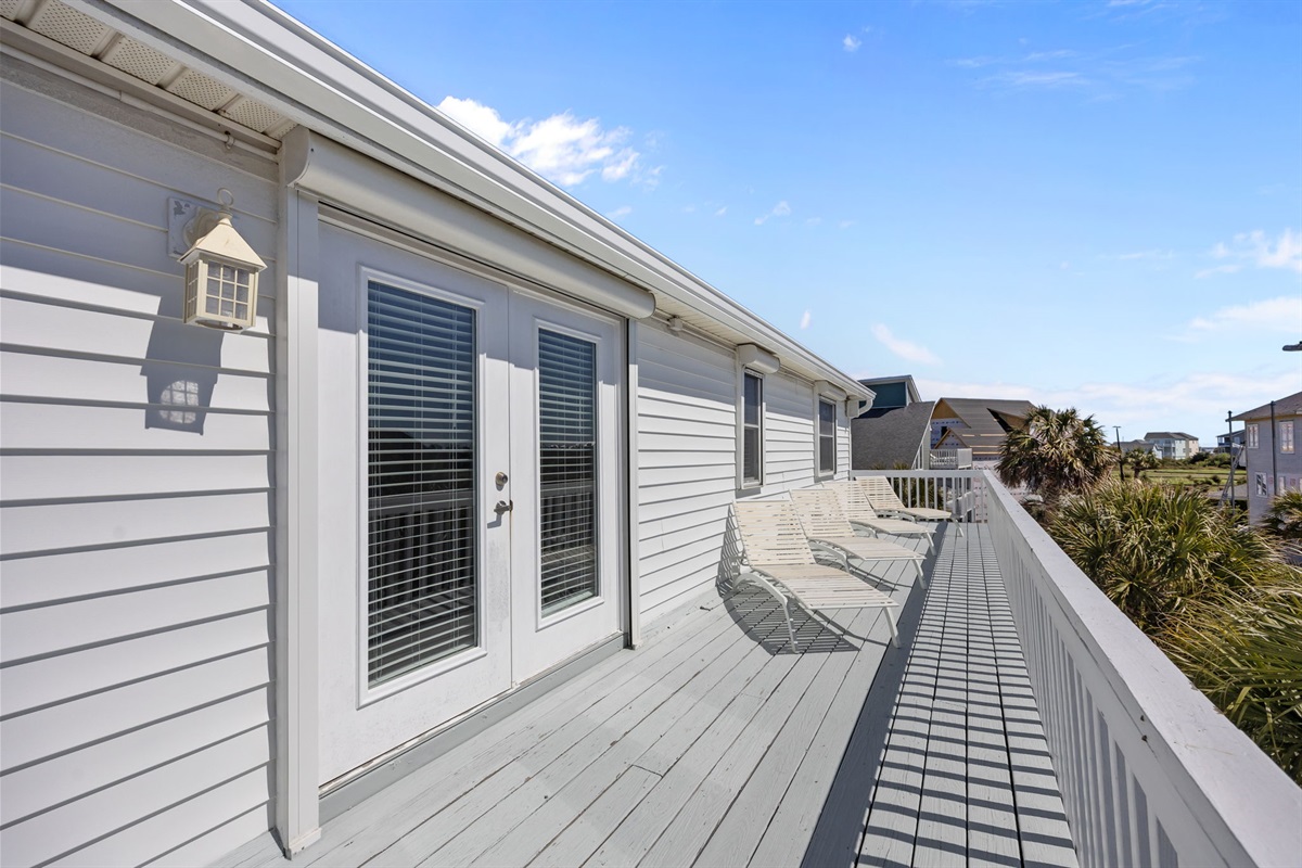 Large wraparound balcony with lounge chairs perfect for relaxing in the sun