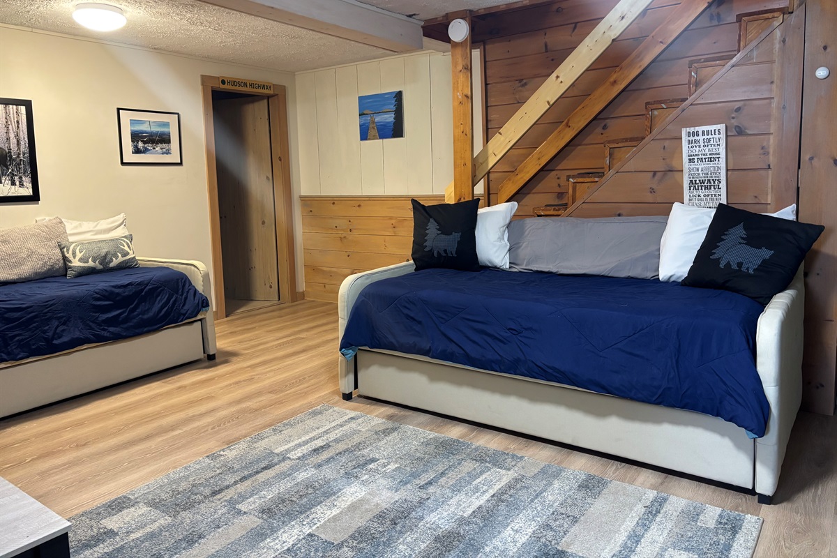 Lower level sitting area with day beds and trundles