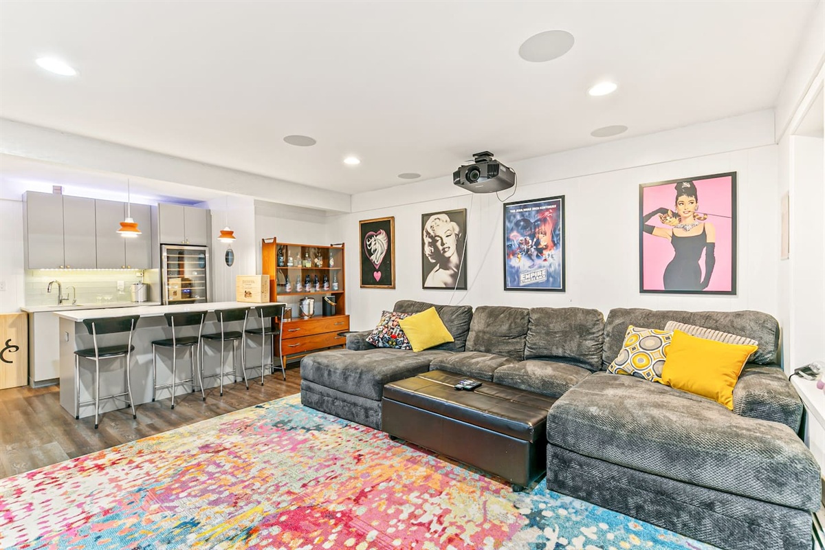 Experience the ultimate home theater with a TV projector, motorized screen, and a full bar. Enjoy the cozy seating and close proximity to the fourth bathroom, bathroom, and game room.