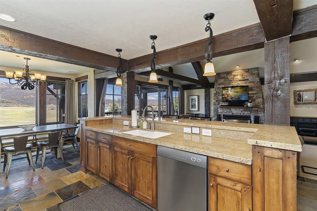 A spacious kitchen with an oversized island and elegant finishes, perfect for gathering, entertaining, and effortless flow into the dining and living areas.