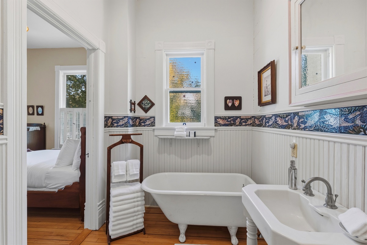 Main floor bathroom w/ tiled walls & clean, simple layout