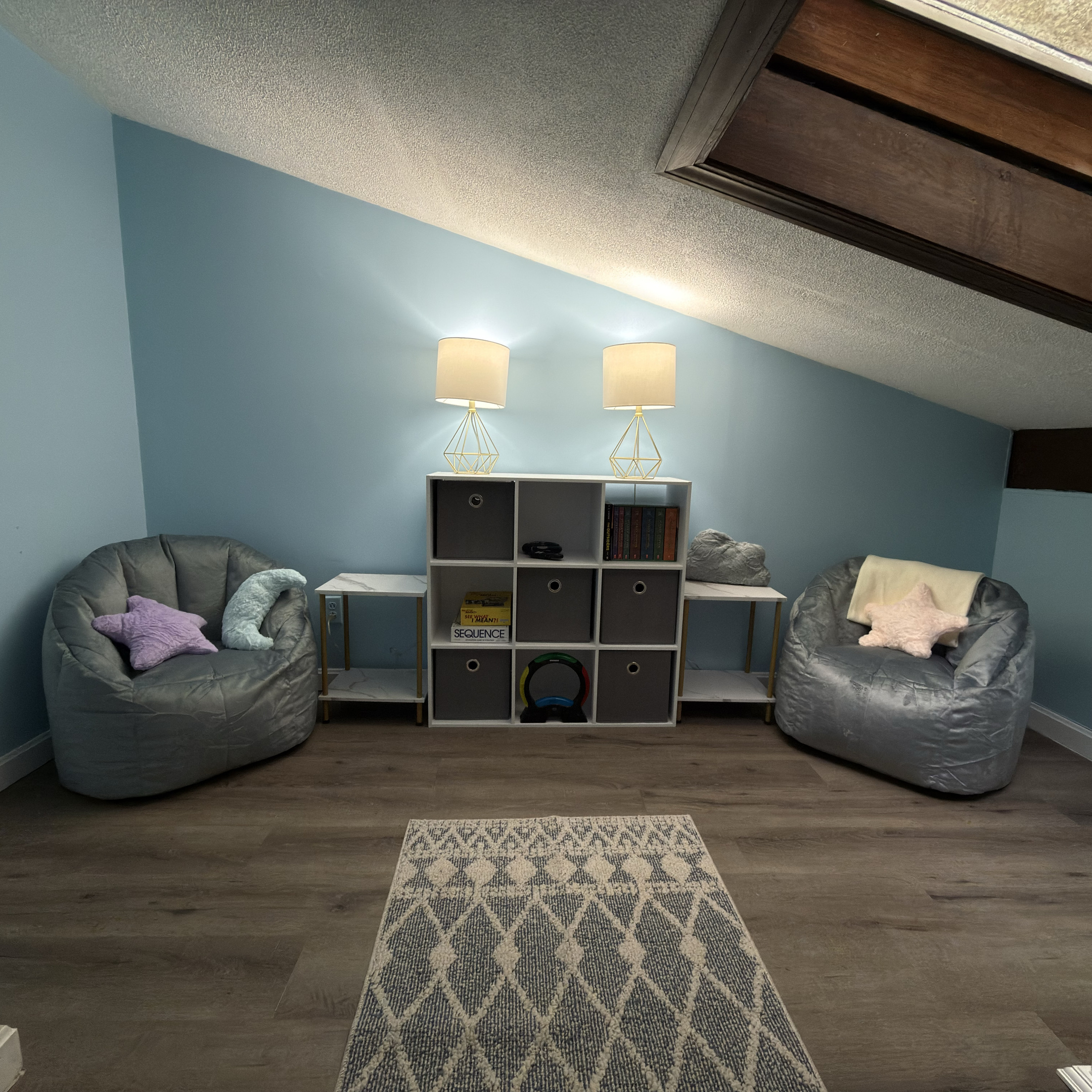 Cozy loft retreat with lounge seating, books, and board games. Perfect for unwinding after a day at the lake.