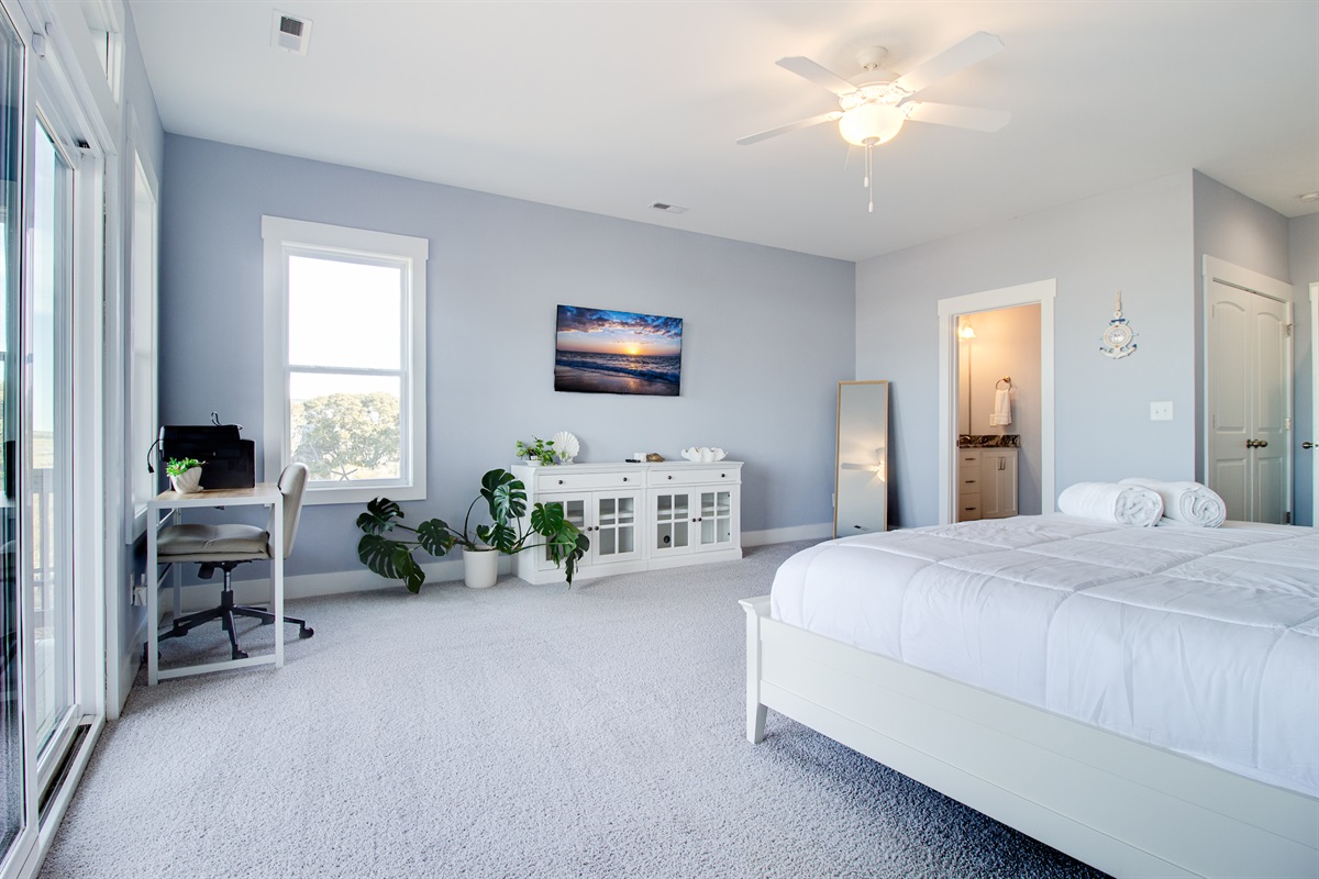 Designed for comfort and space, this primary suite features multiple windows and a peaceful, open layout