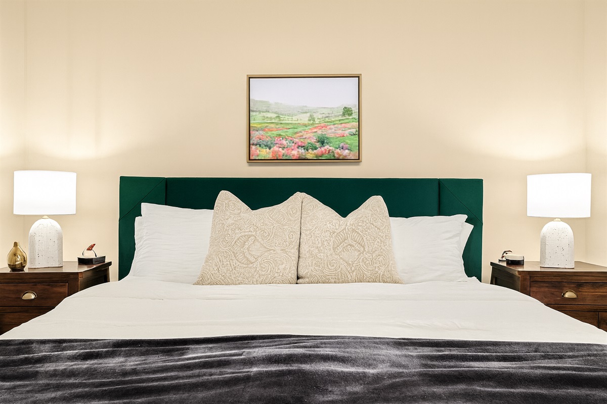 Indulge in the comfort of our king-size bed adorned with luxurious linens and pillows.