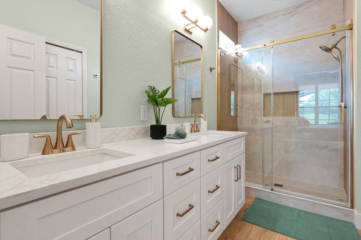 Moana King Suite Ensuite: Completely renovated ensuite with a double vanity, custom-tiled walk-in shower and champagne-bronze finishes.