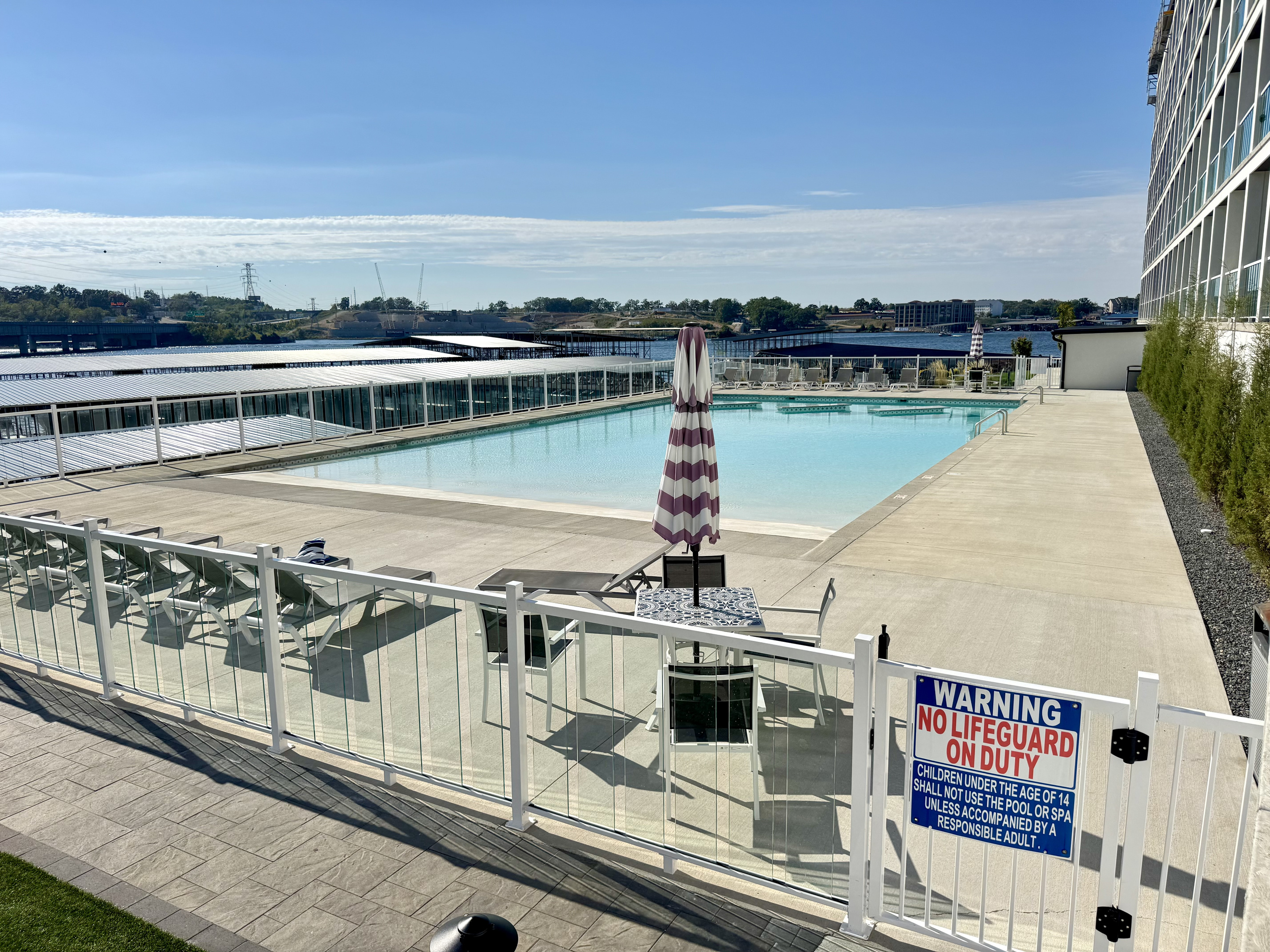 Pool 1: Beach access entry to both pools, lounge chairs, and tables. Pool 1 has fountains and three tables in the zero-to-4' deep pool. A set of bathrooms is located near each pool.