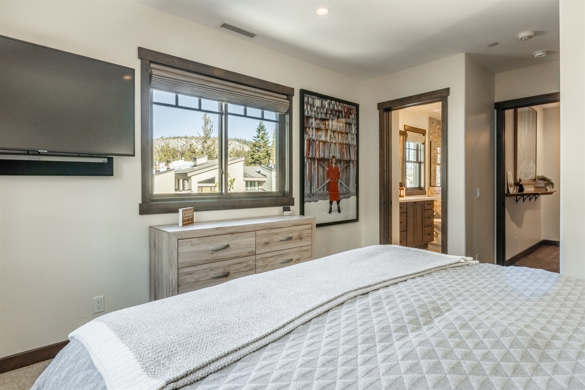 Peekaboo views of the ski hill add a fun mountain touch to this second primary suite, complete with its own private en-suite bath—perfect for guests who want comfort, privacy, and a hint of slope-side energy.