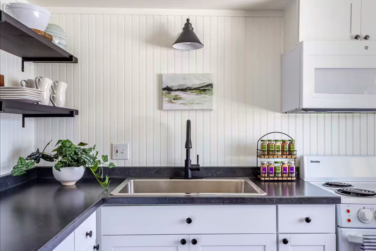 Natural light, greenery, and thoughtful touches make even dishwashing feel a little less like a chore.