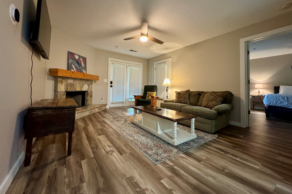 🛋️ Relax in the living room with a gas log fireplace, Roku TV, and open flow into the bedroom.