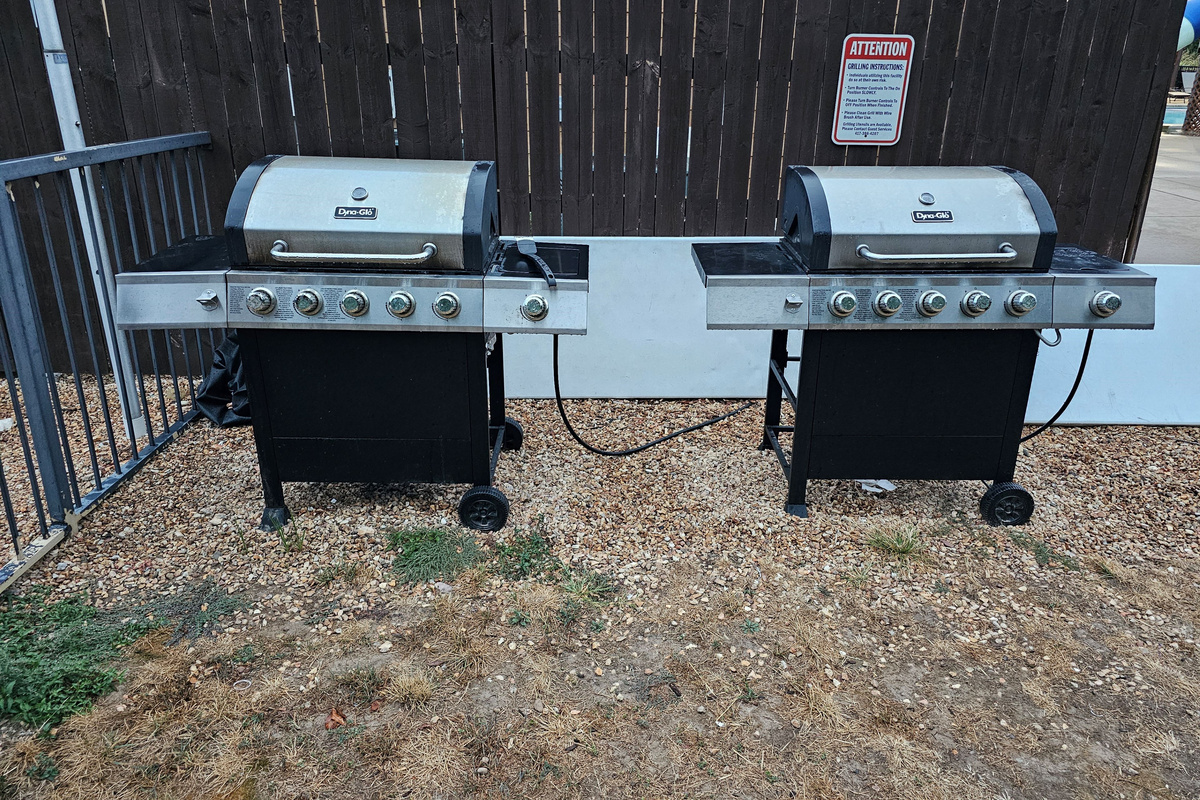 Outdoor community gas grills ready for cookouts & family dinners