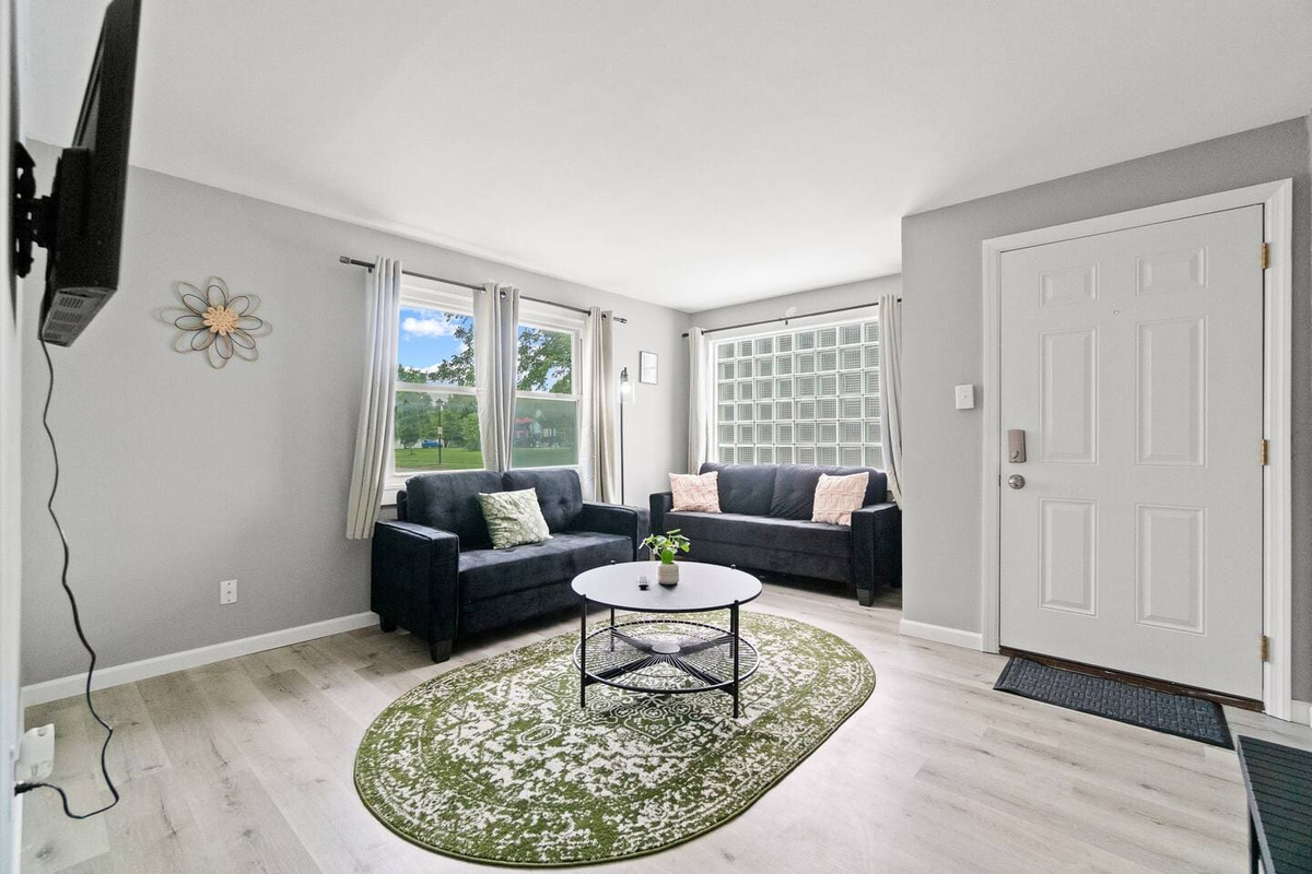 Bright and welcoming living room with a comfy couch and a stylish mini center table, perfect for relaxing.