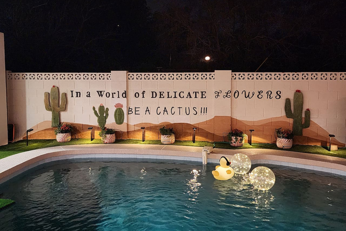 A space with personality and desert charm. The illuminated mural, cactus accents, and glowing pool create a distinctive Arizona vibe guests love to enjoy and photograph.