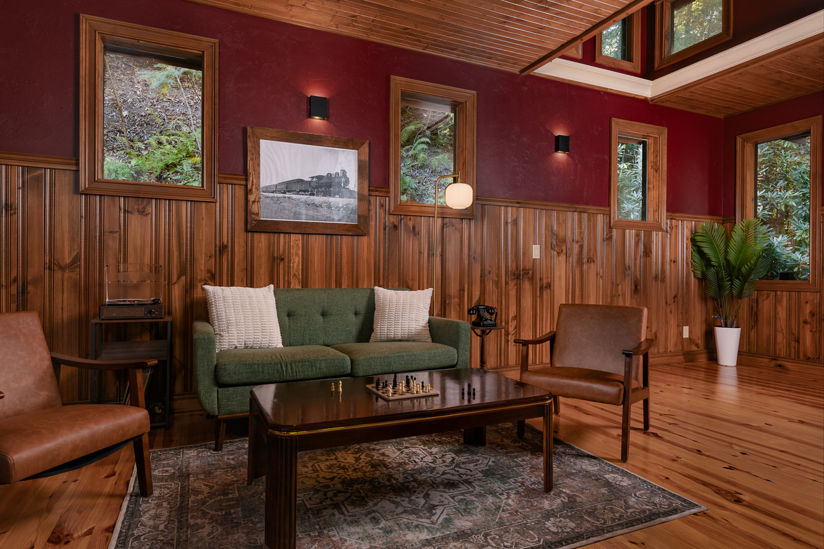 {Lookout Lounge Caboose} Step inside the hidden caboose for a cozy second lounge tucked into the woods—perfect for a quiet drink, conversation, or a little escape from the main house.