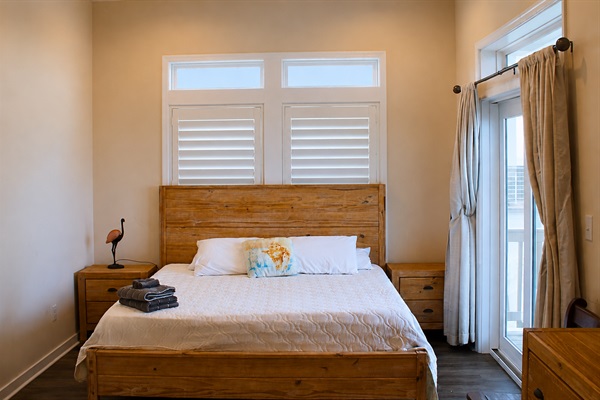 Master Bedroom: Sun-drenched retreat with beach views and modern wooden accents! Relax and unwind.