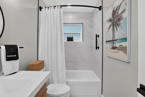 The second full bathroom offers a tub-and-shower combination with bright, modern finishes.
