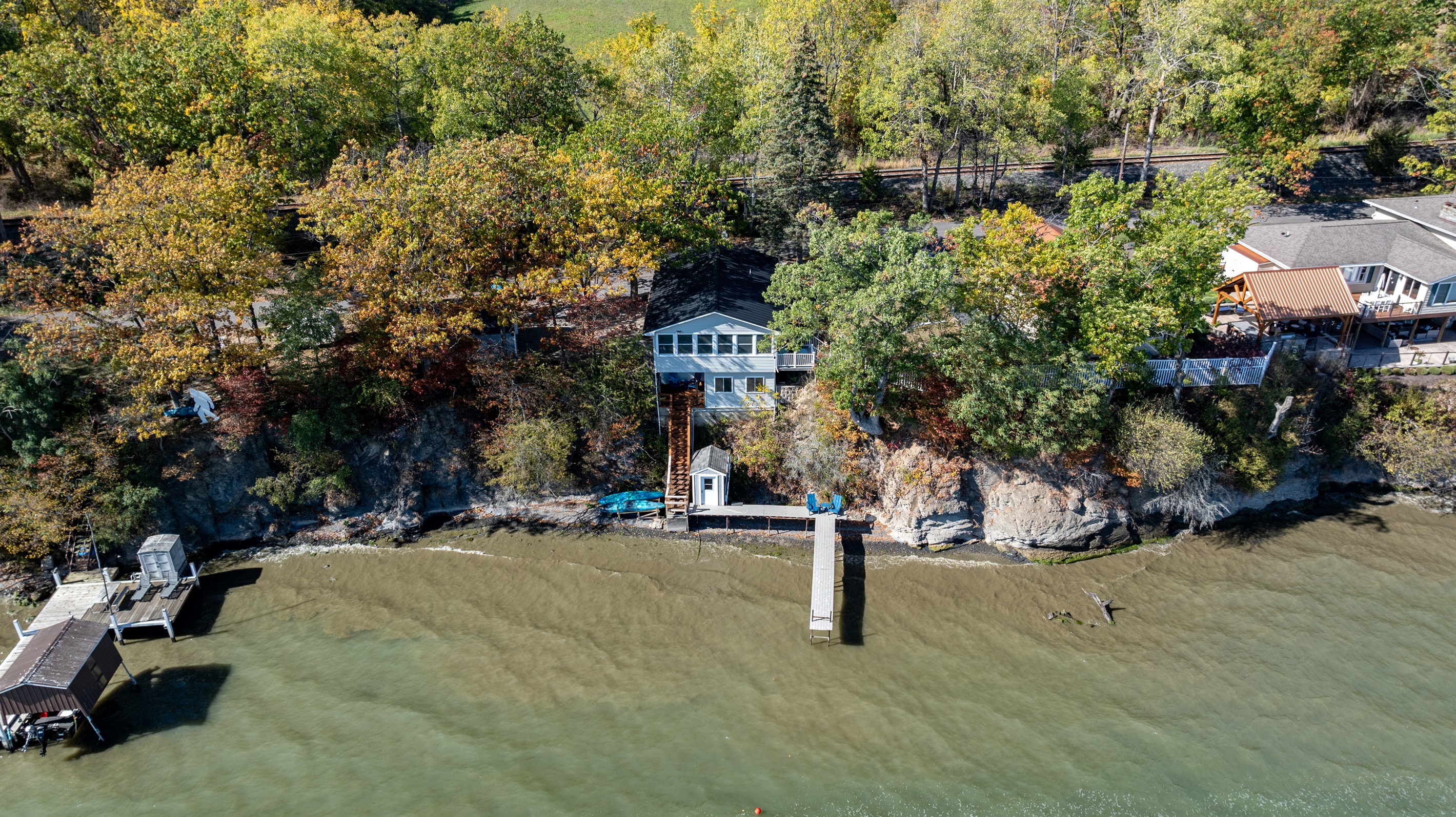 Signature blue lake house perched right above the water—picture-perfect Finger Lakes gem