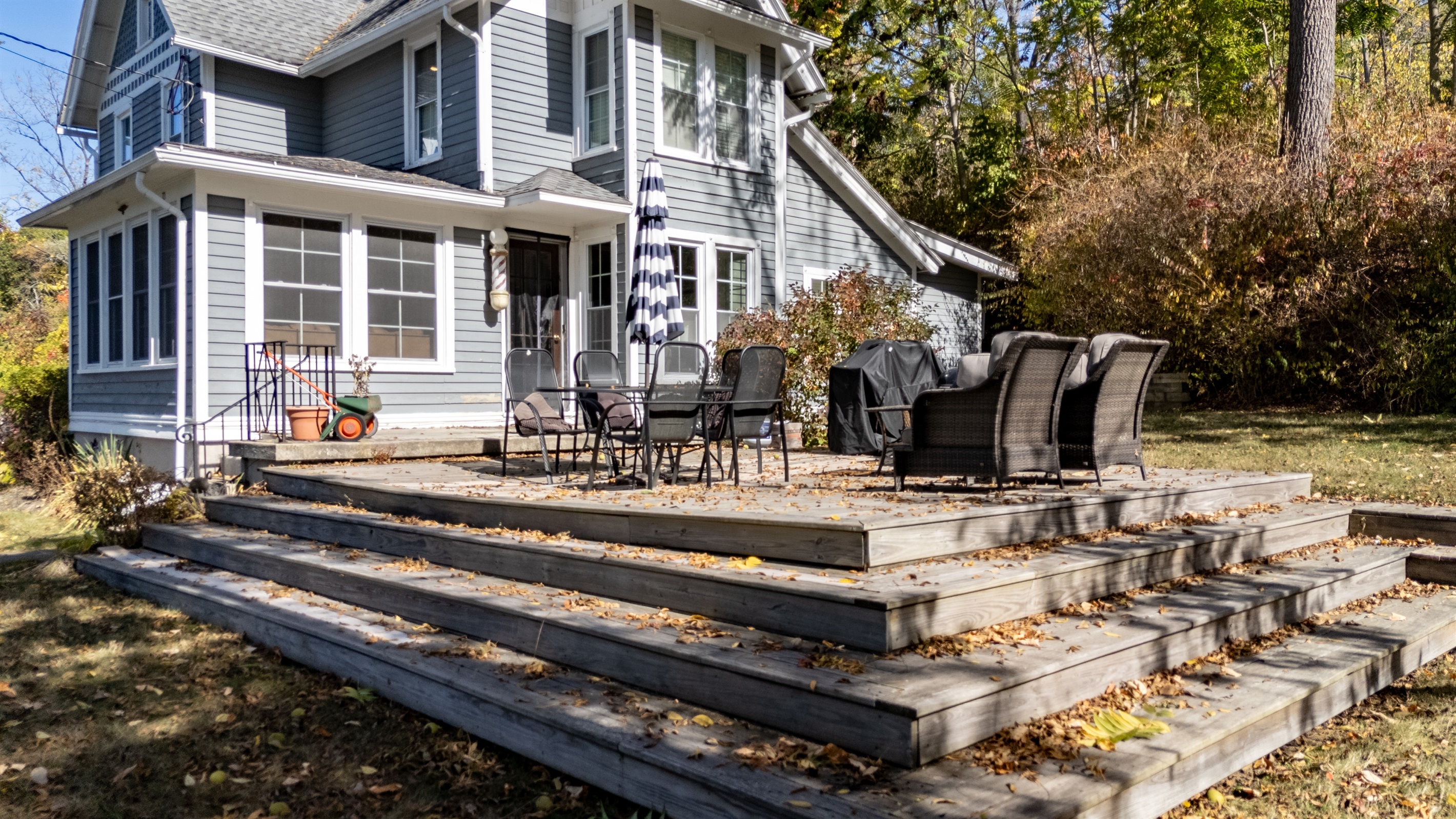 Sprawling patio with cozy seating for evening cocktails and family BBQs — lake views included