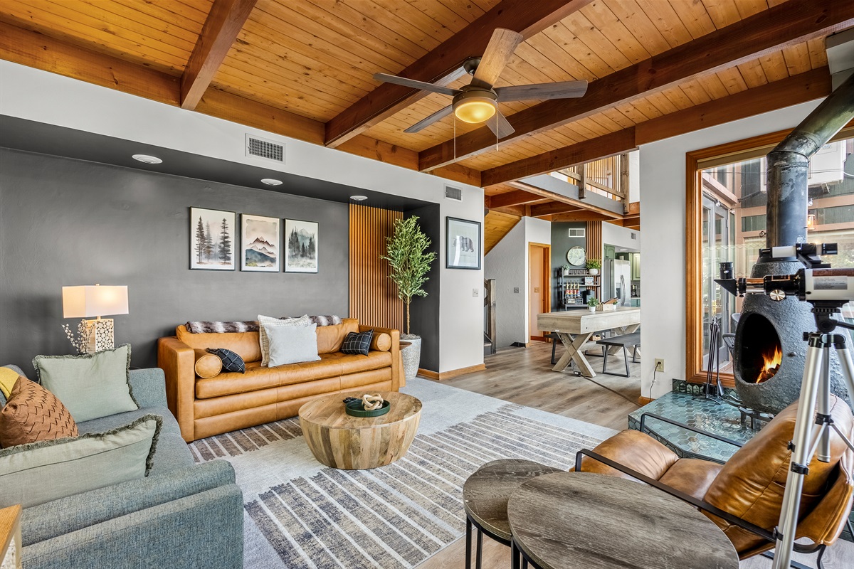 Spacious living room with real fire place, floor to ceiling windows and tons of seating to unwind and gather!
