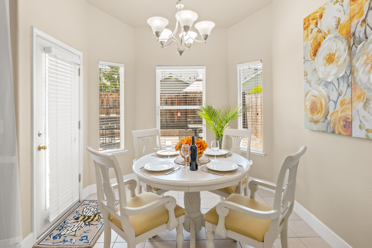 Enjoy meals in this charming dining area featuring comfortable seating, abundant natural light, and easy access to both the kitchen and outdoor living spaces.