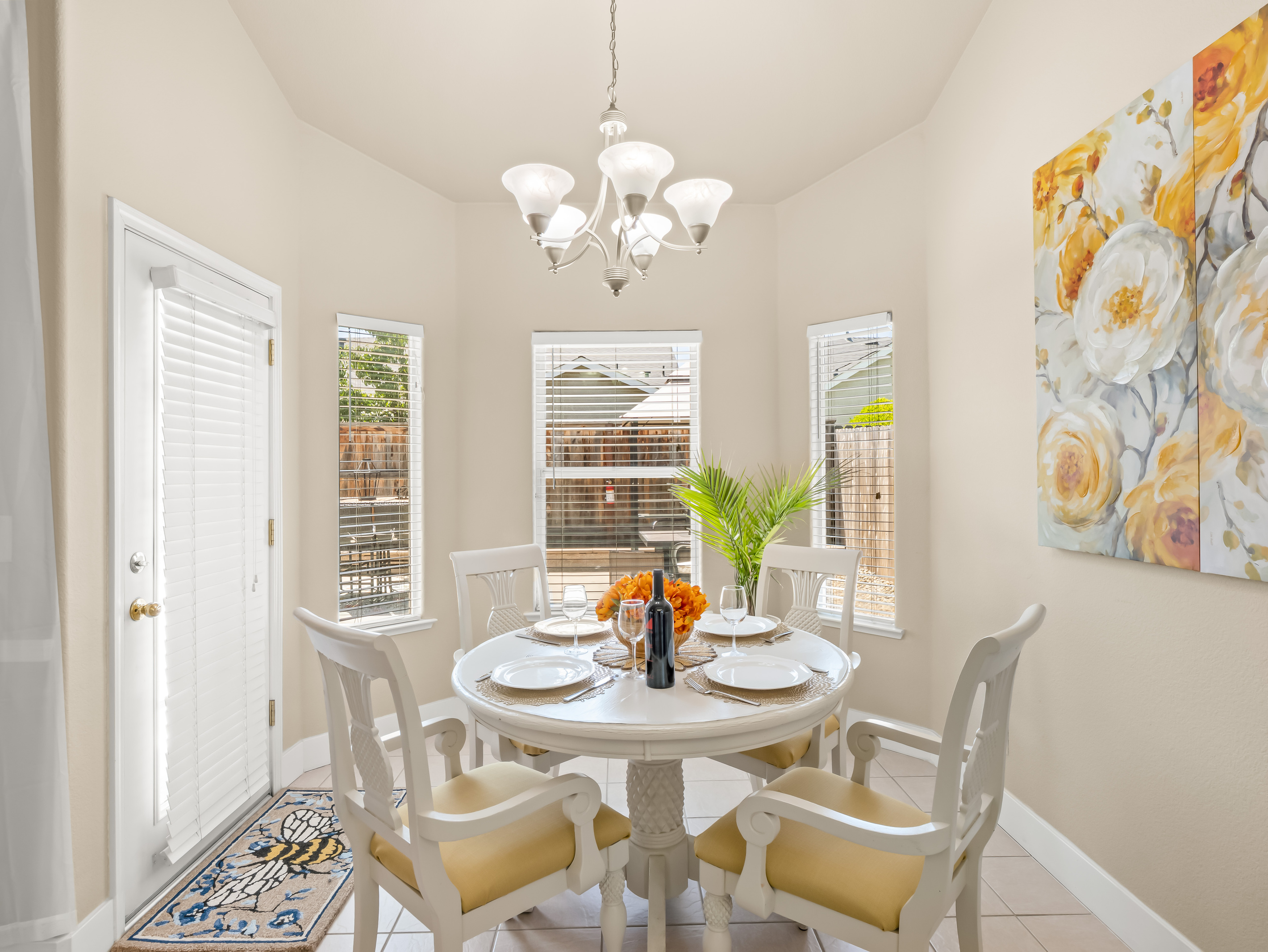 Enjoy meals in this charming dining area featuring comfortable seating, abundant natural light, and easy access to both the kitchen and outdoor living spaces.