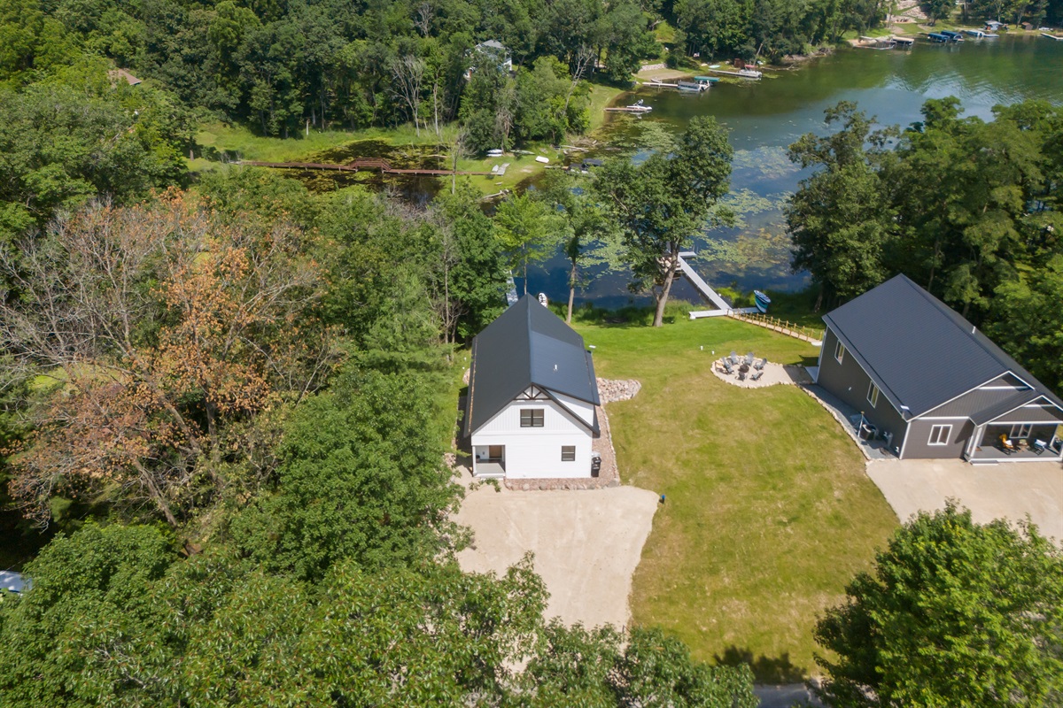 The drone view highlights the roomy driveway and gives a clear look at how close the neighboring homes are—great for guests who like to know the layout ahead of time.