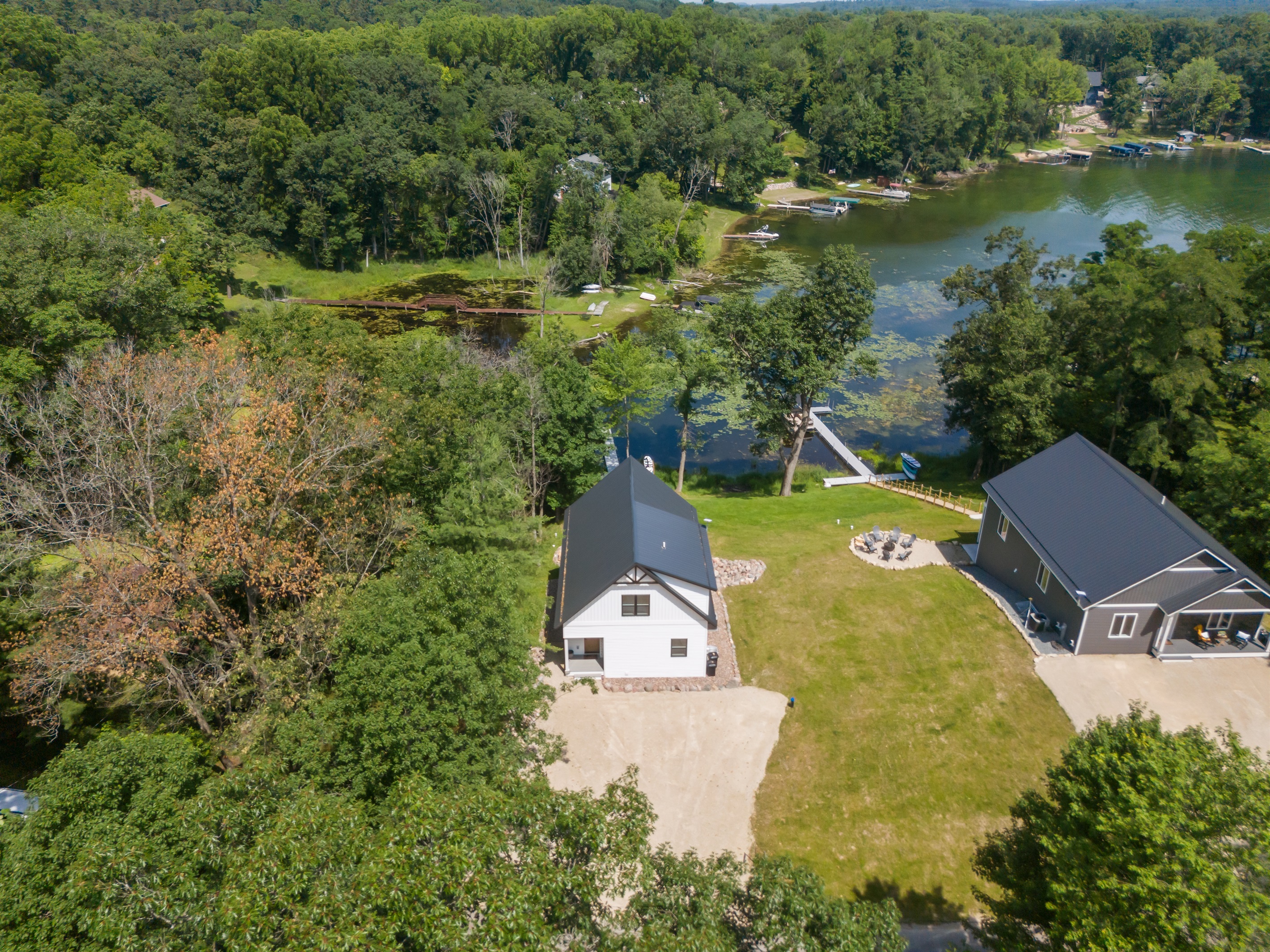 The drone view highlights the roomy driveway and gives a clear look at how close the neighboring homes are—great for guests who like to know the layout ahead of time.