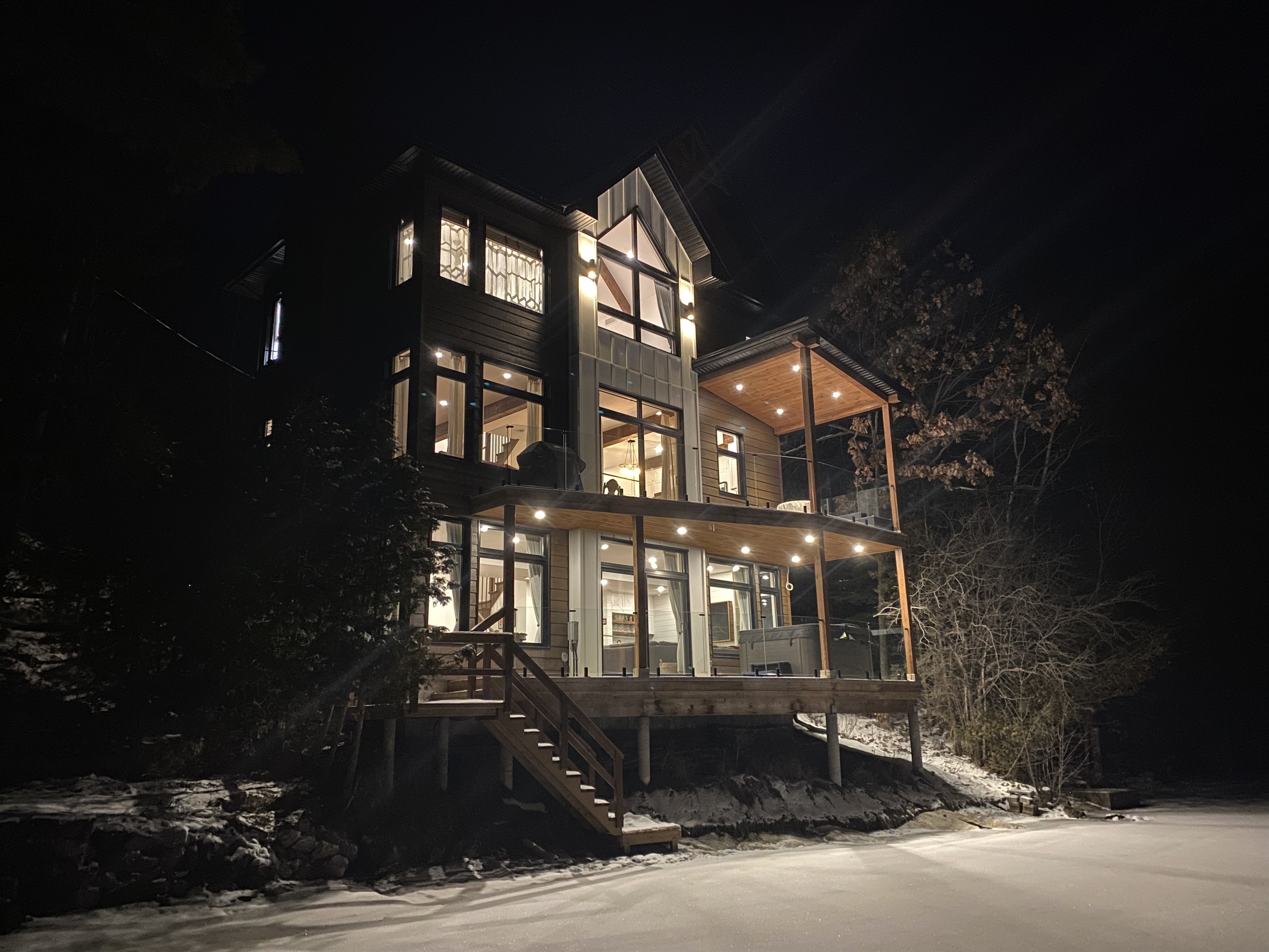 Cottage seen from edge of lake and beach area