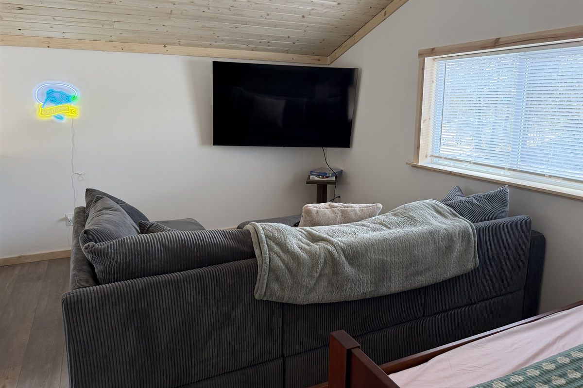 Loft living area - sectional sofa and big screen tv.