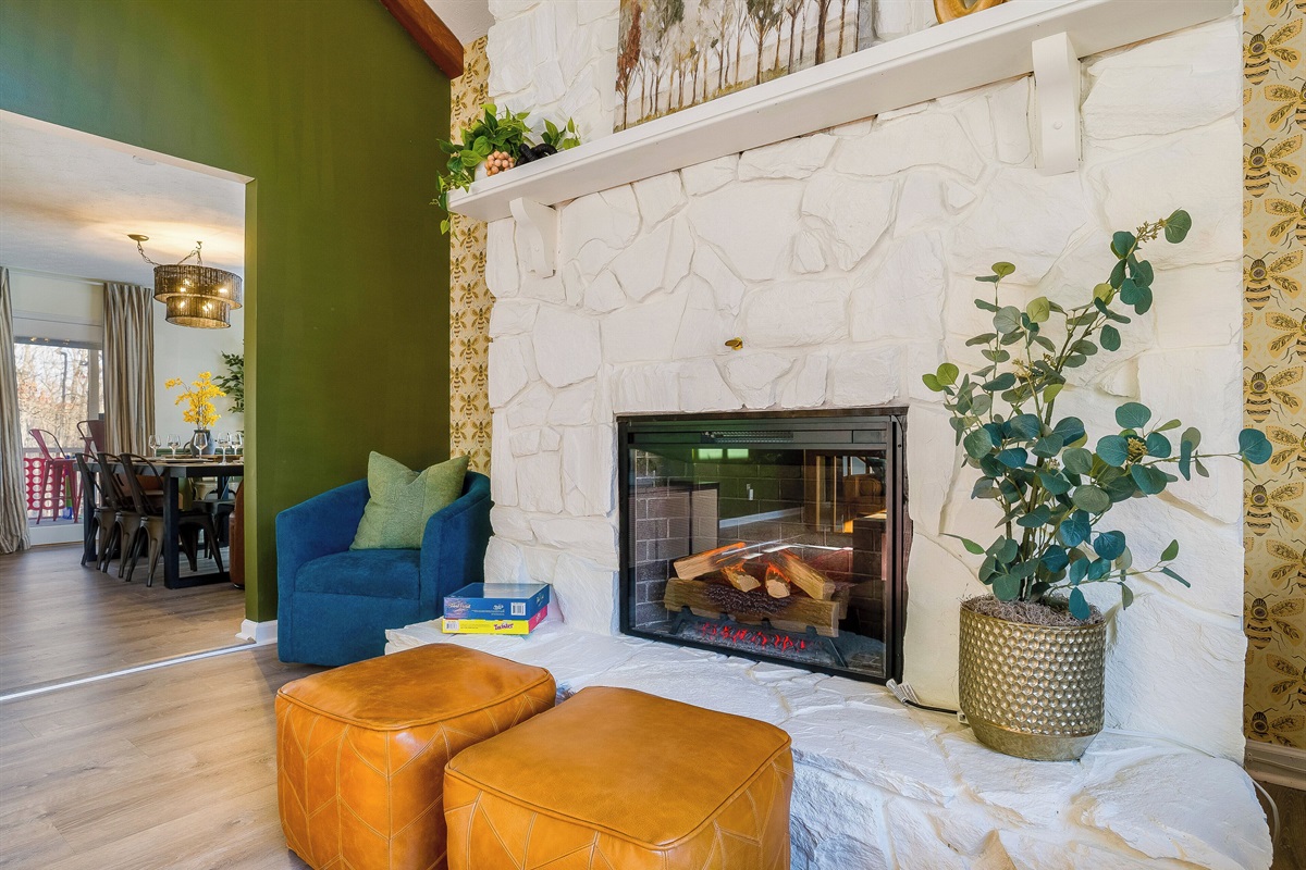 cozy fire place with a couple poufs to put up your feet or guest to sit on while you play games