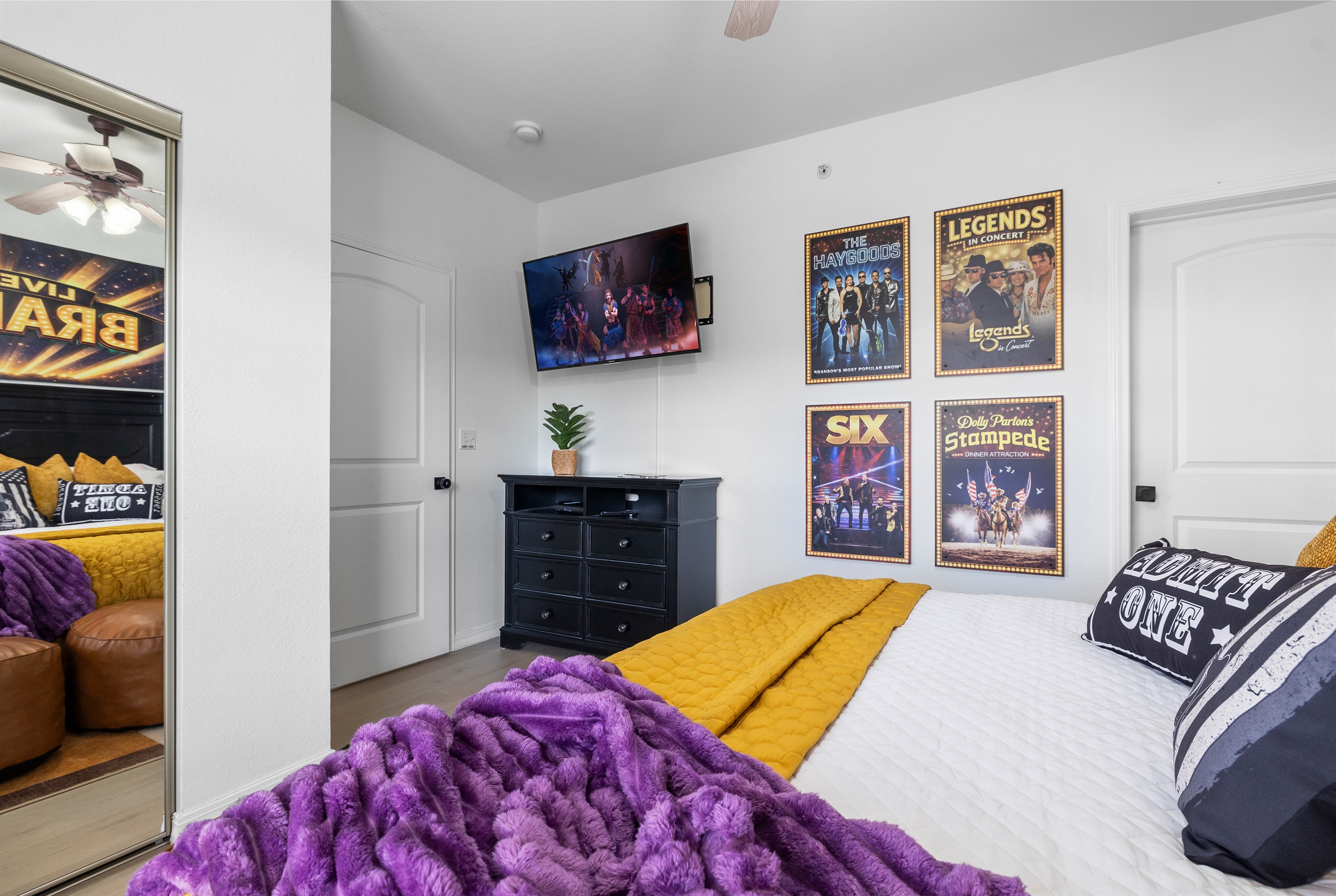 The Music room has a large smart TV, custom artwork a dresser and attached ensuite bathroom